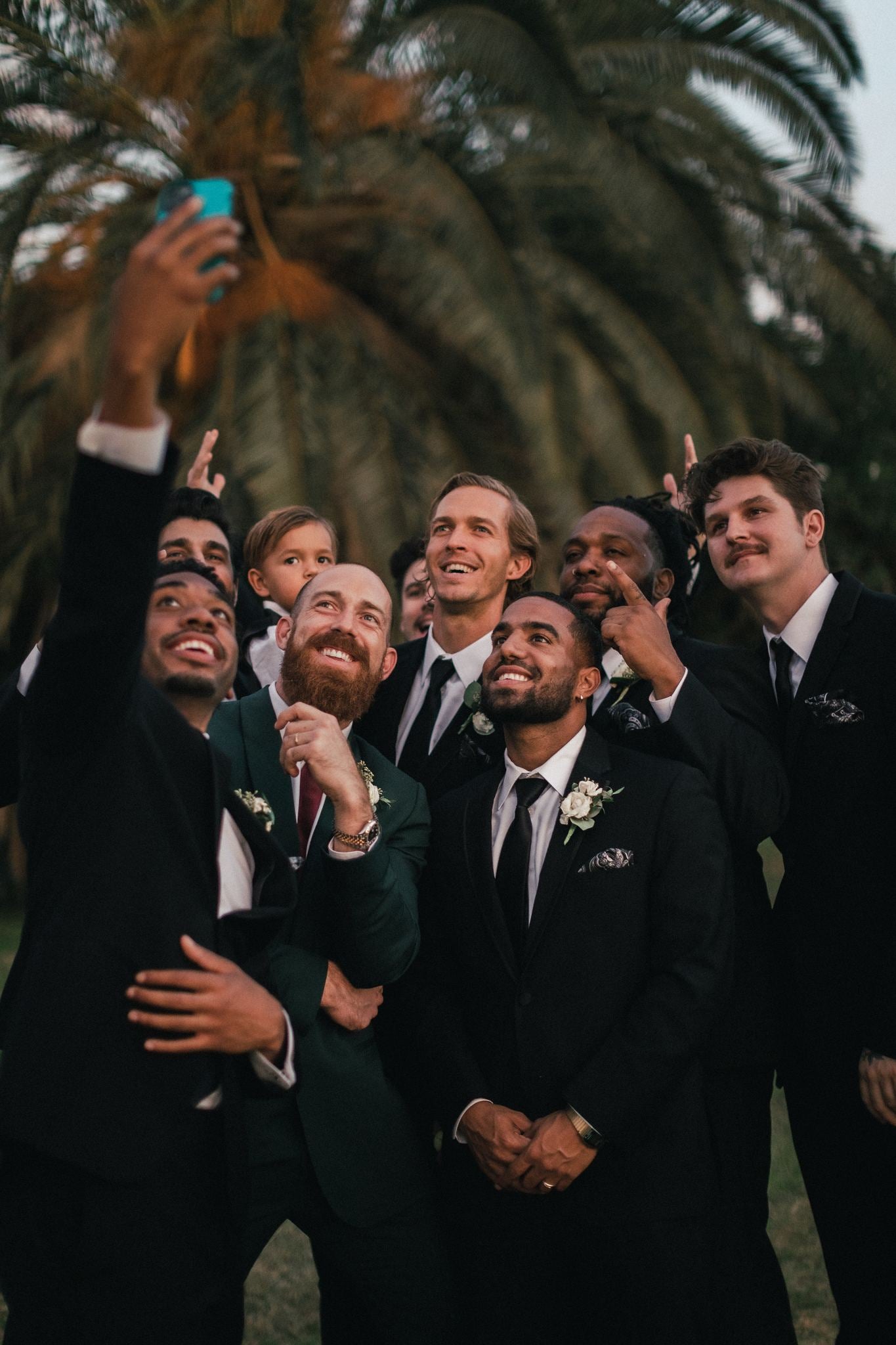 Group of groomsmen’s wearing custom made suits and tuxedos