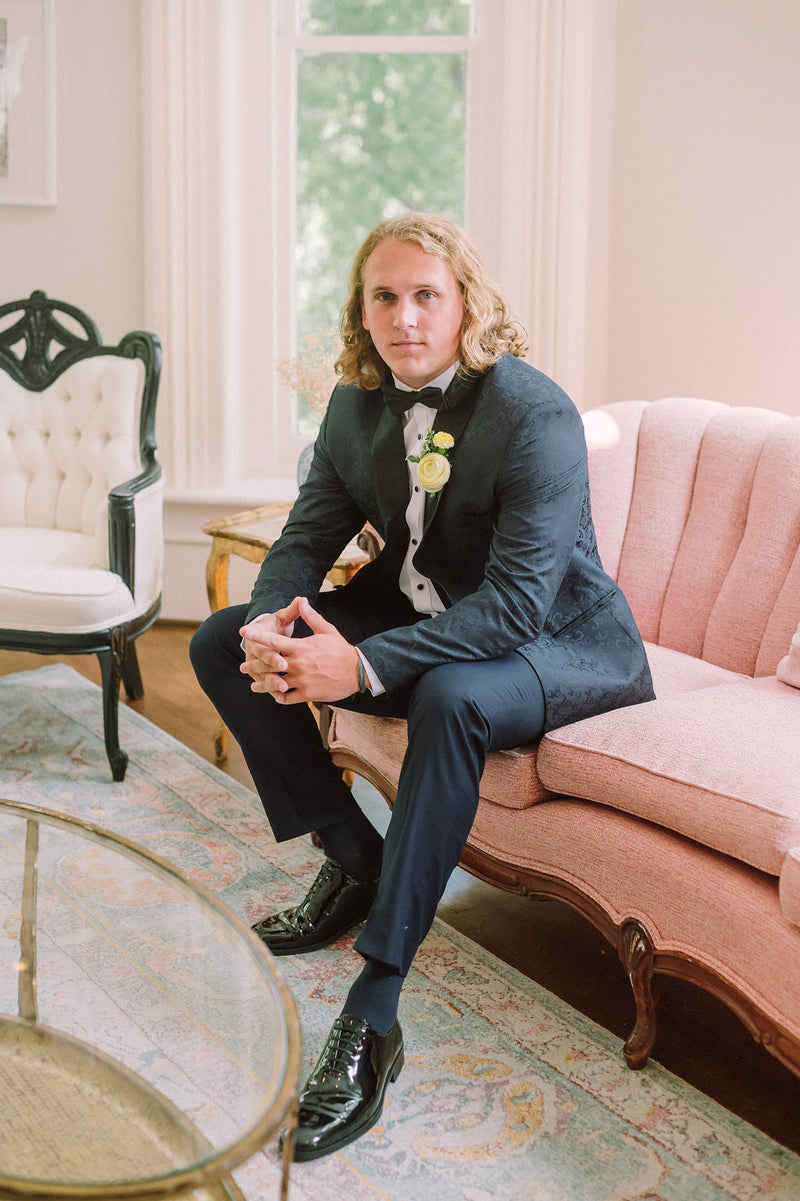 Navy tux, pink sofa