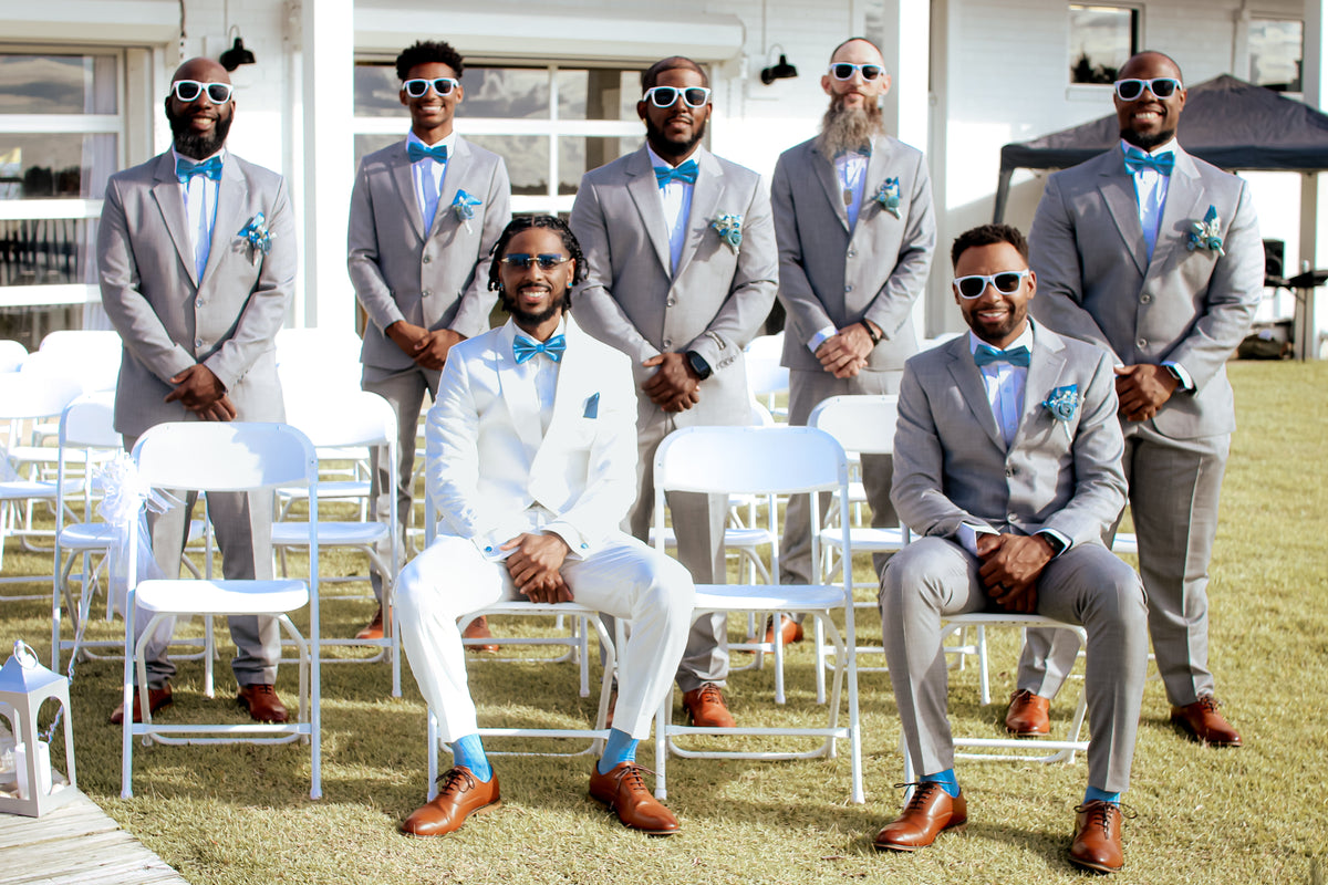 White for the groom, grey for the crew — waterfront vows