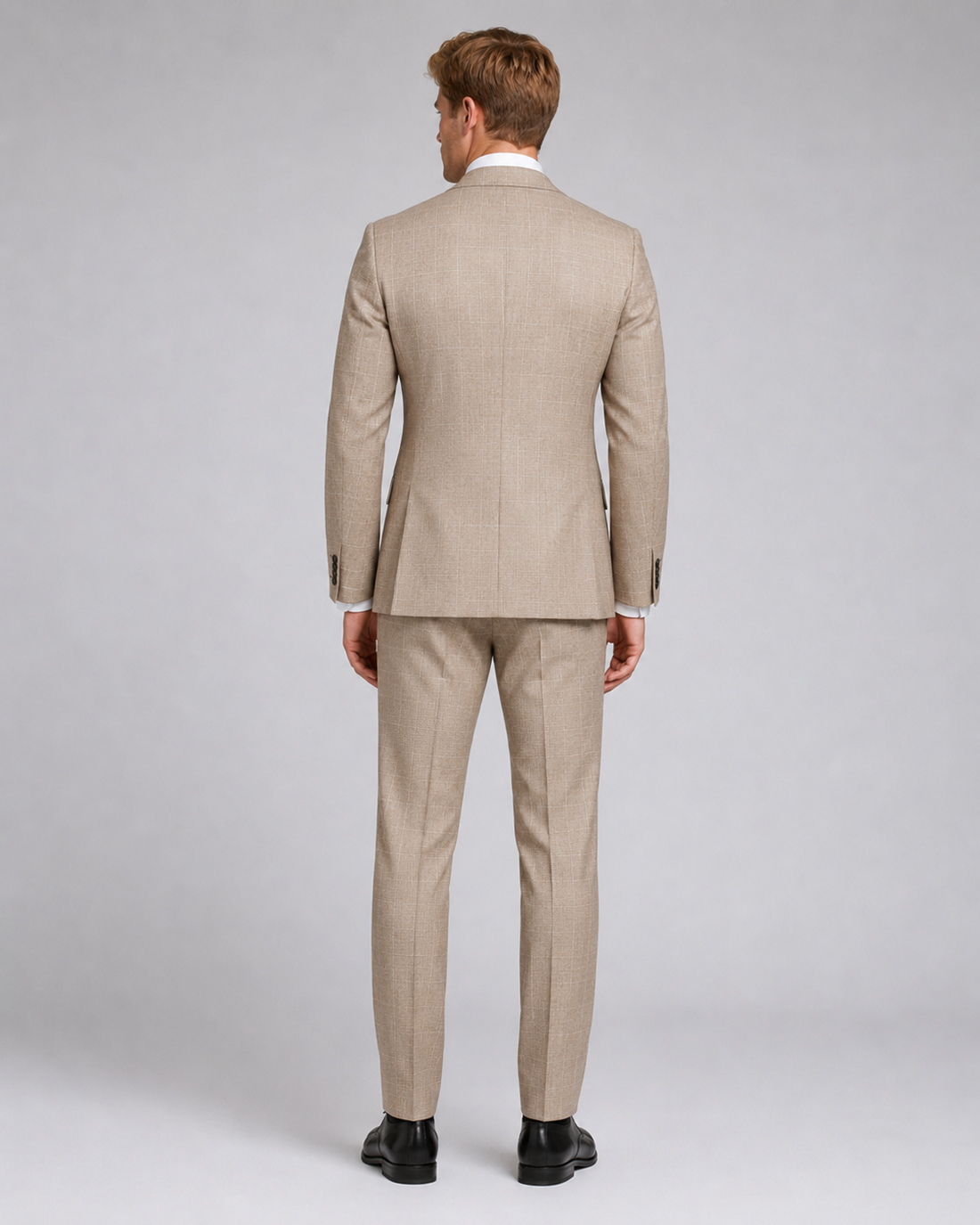 Back view of light beige tailored suit with subtle classic pattern