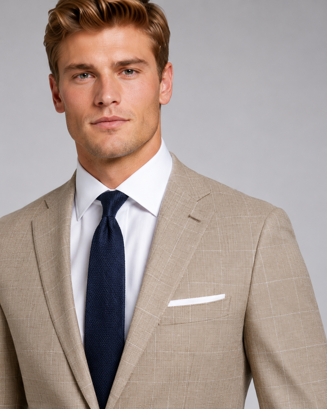 Close-up of sand beige suit texture with subtle windowpane detailing