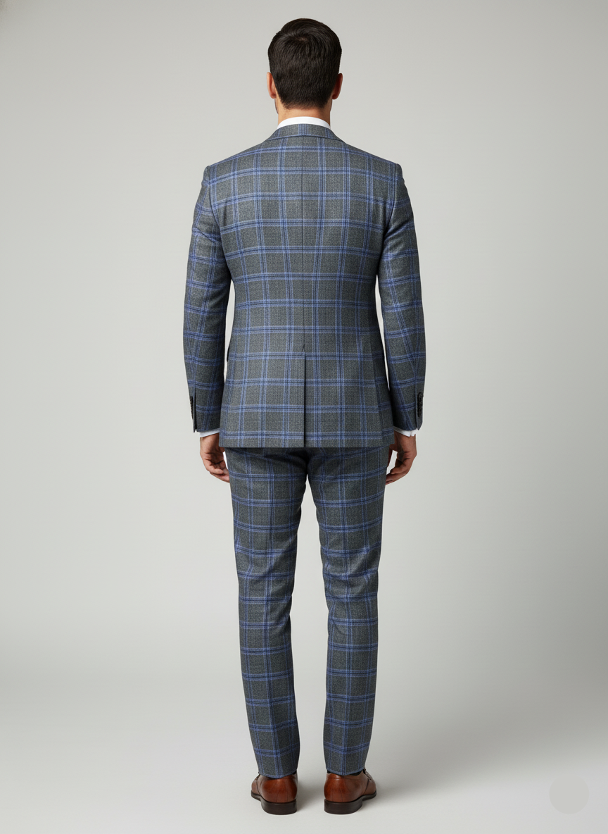 Man wearing a blue plaid suit on a gray background