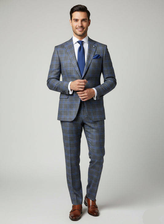 Man wearing a blue plaid suit with a white shirt and brown shoes on a gray background