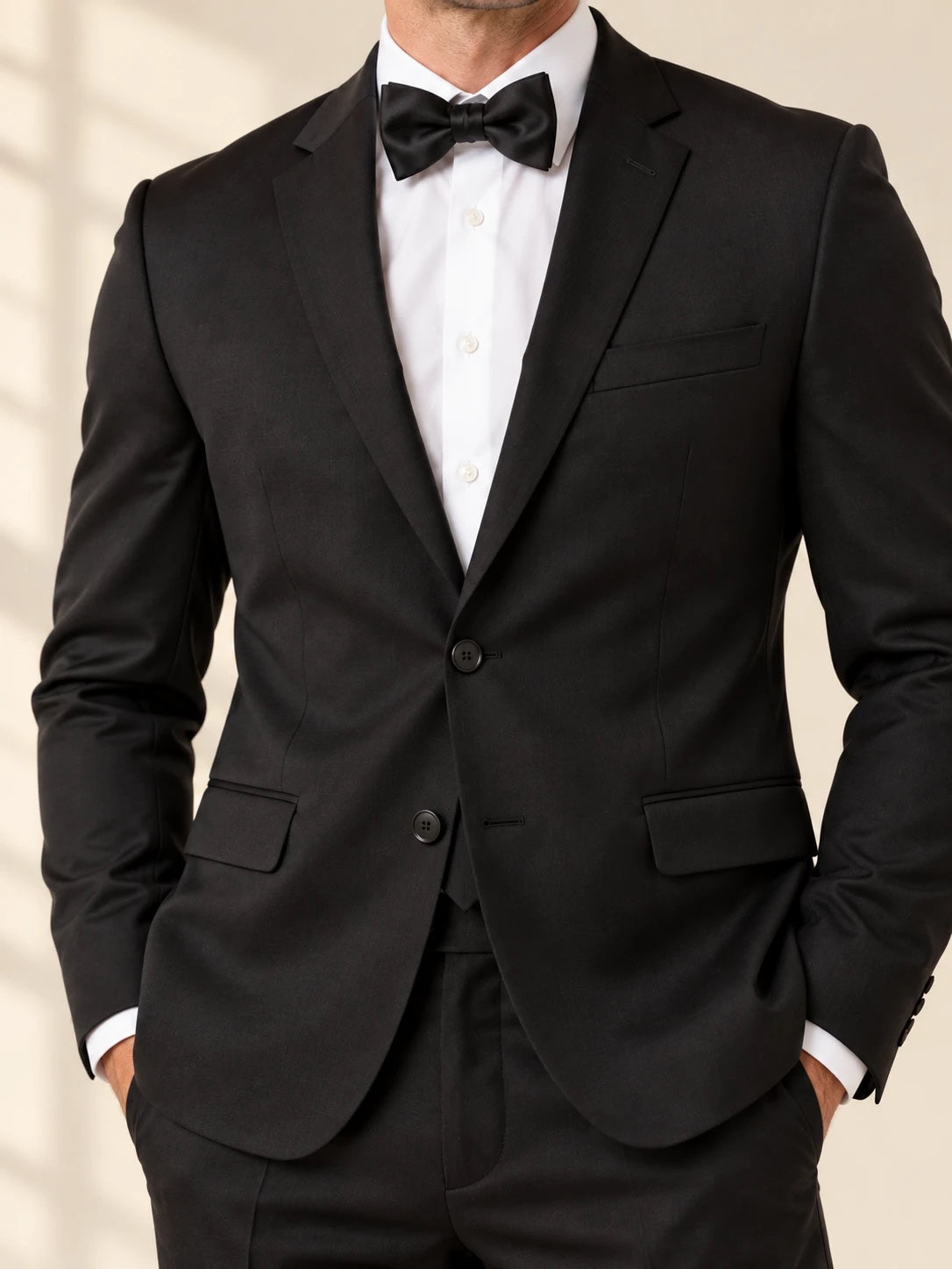 Black suit close-up with white shirt and black bow tie