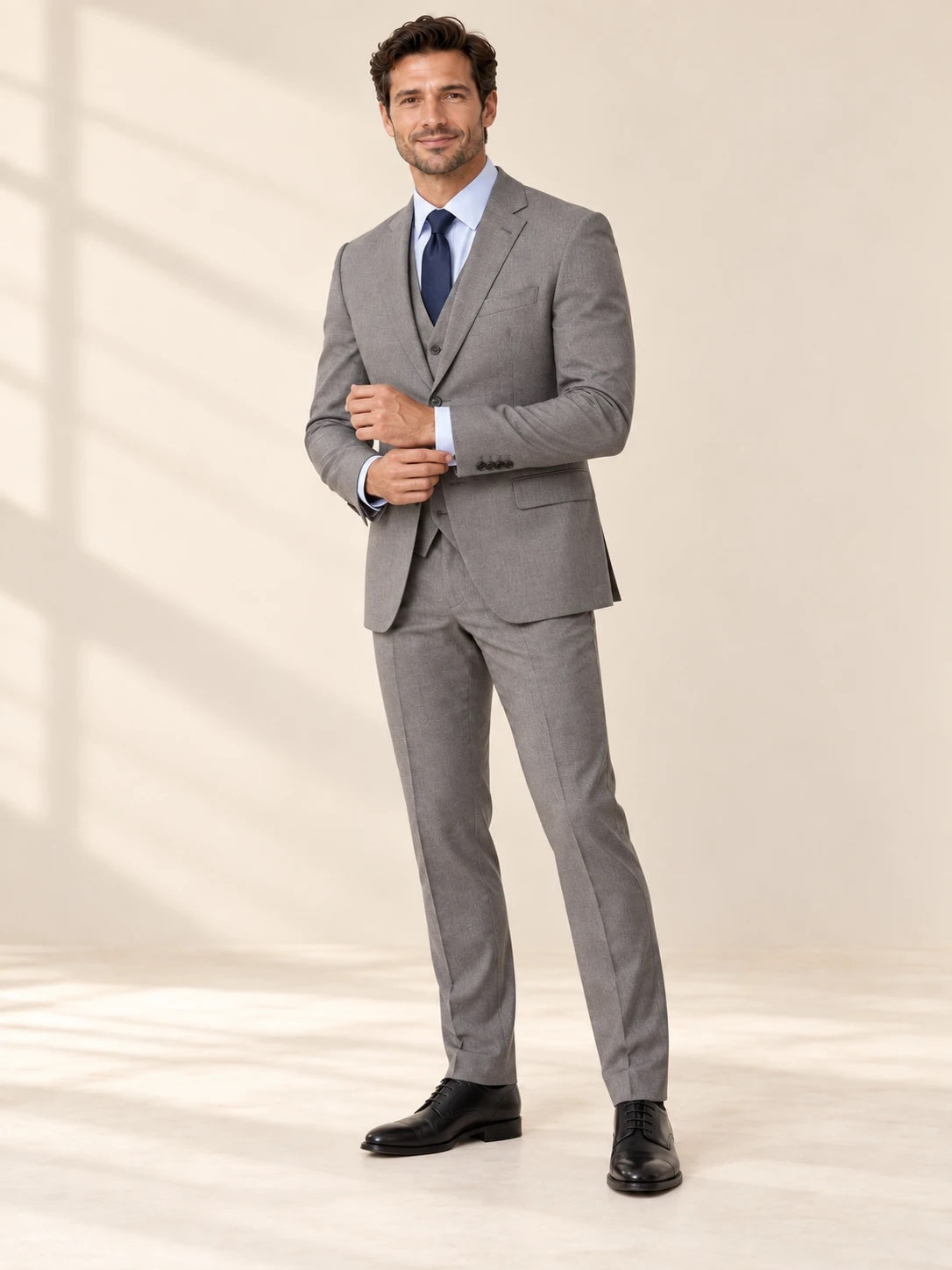 Gray suit styled with a light blue shirt and navy tie