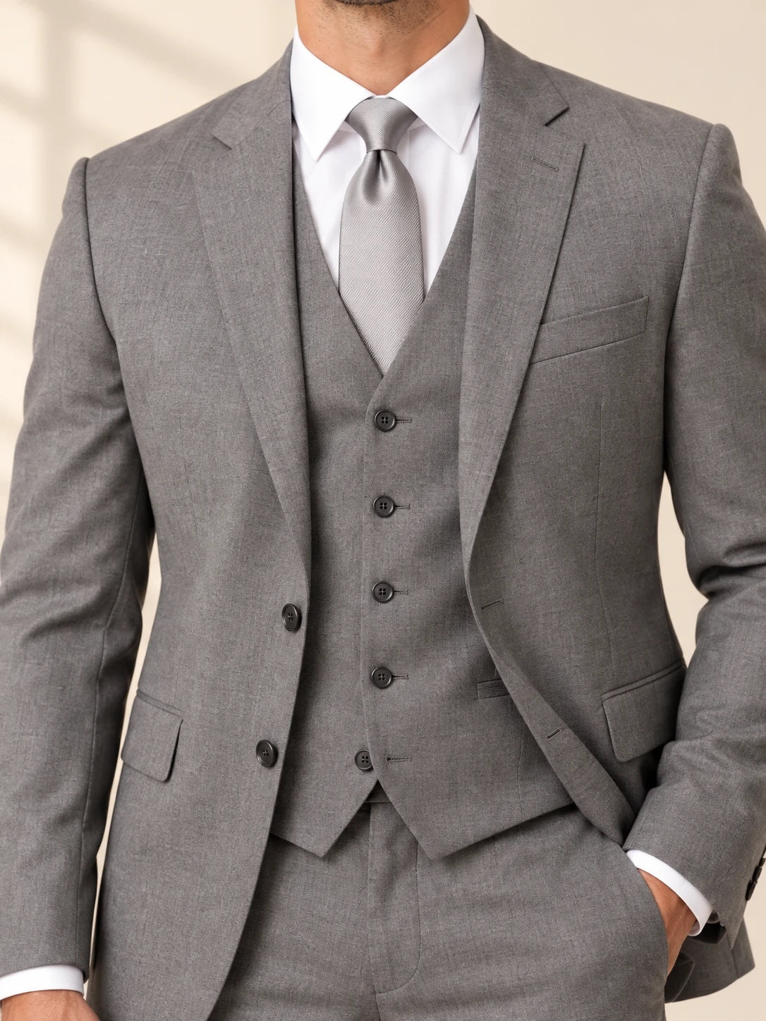 Gray suit close-up of vest, lapel and silver tie