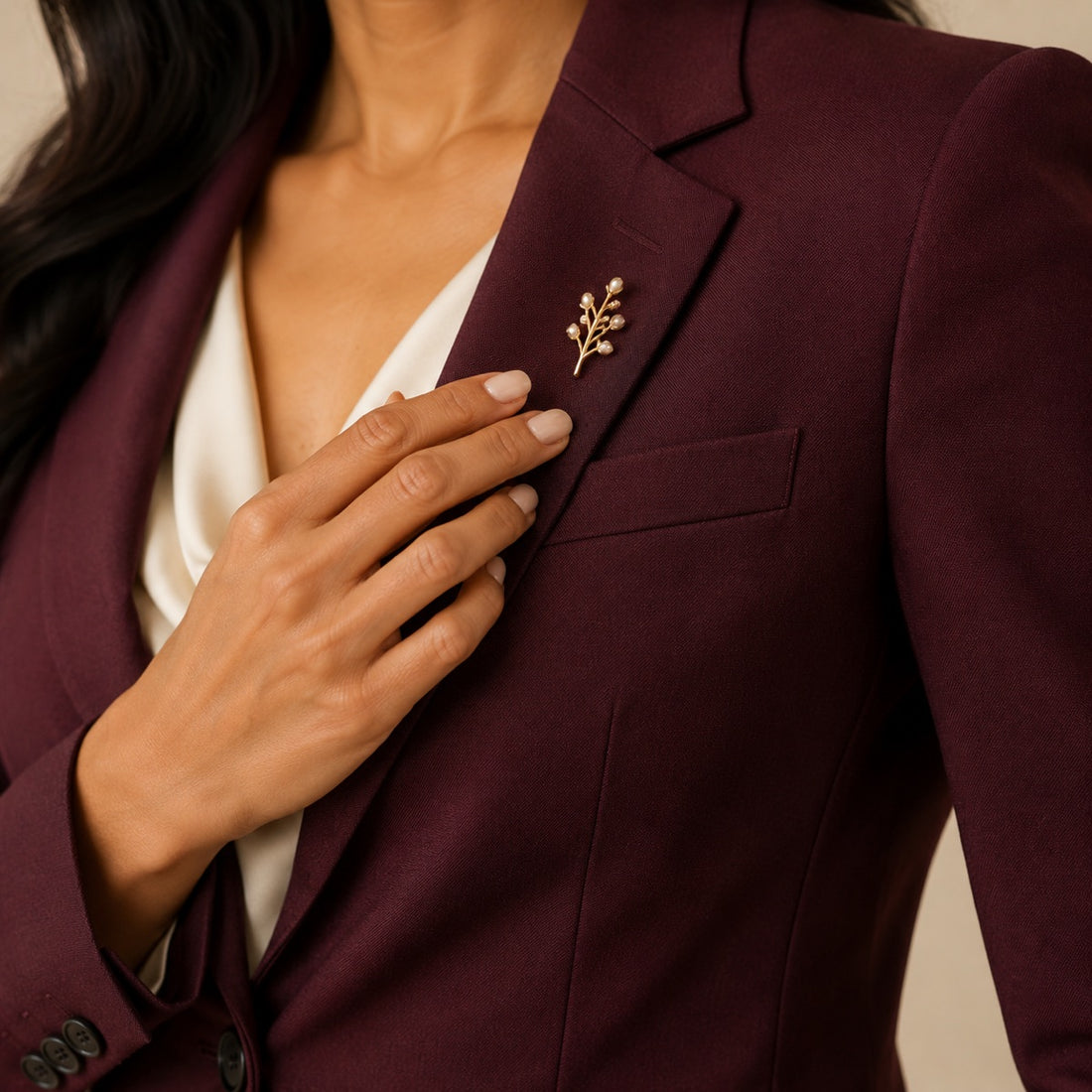 Burgundy lapel with gold brooch detail