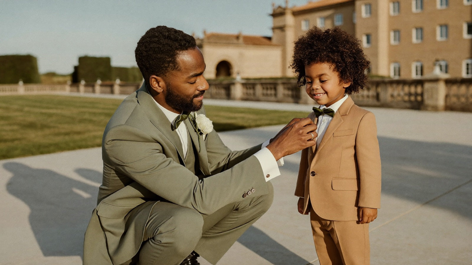 Groom straightening the ring bearer's bow tie before the ceremony