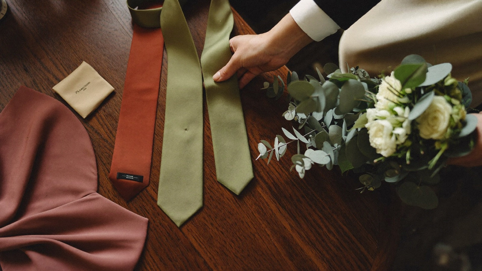 Ties and pocket squares color-matched to the bridesmaid dress fabric and florals