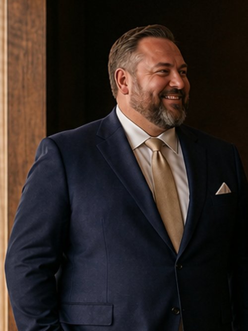Big build in a fitted navy suit