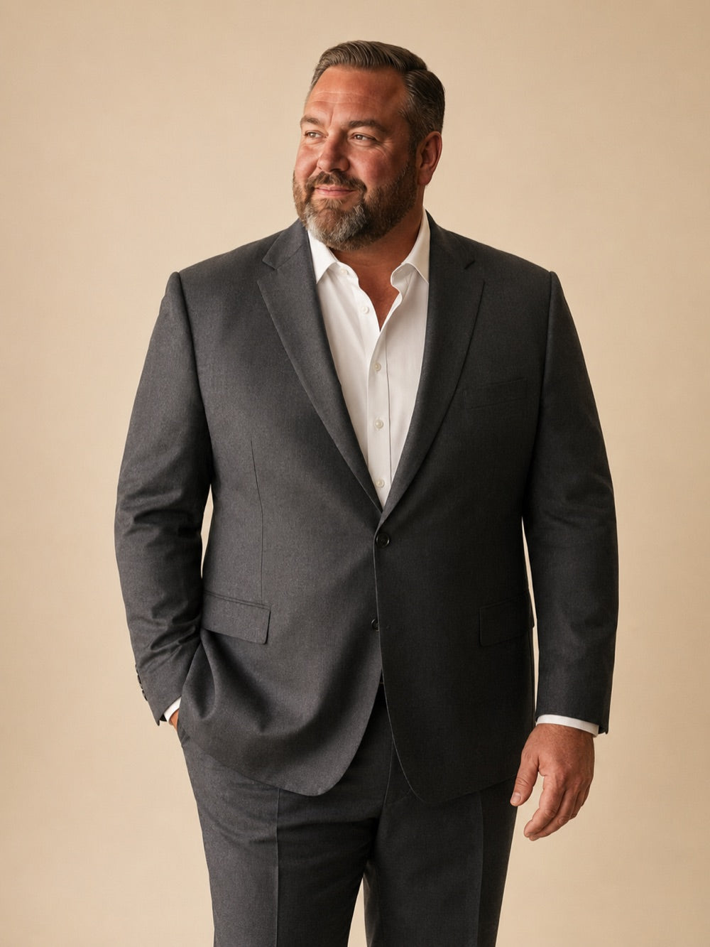 Big and tall man in a perfectly fitted charcoal suit